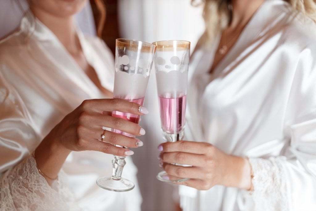 Two ladies celebrating with the help of a Swoosh Finance Wedding Loan