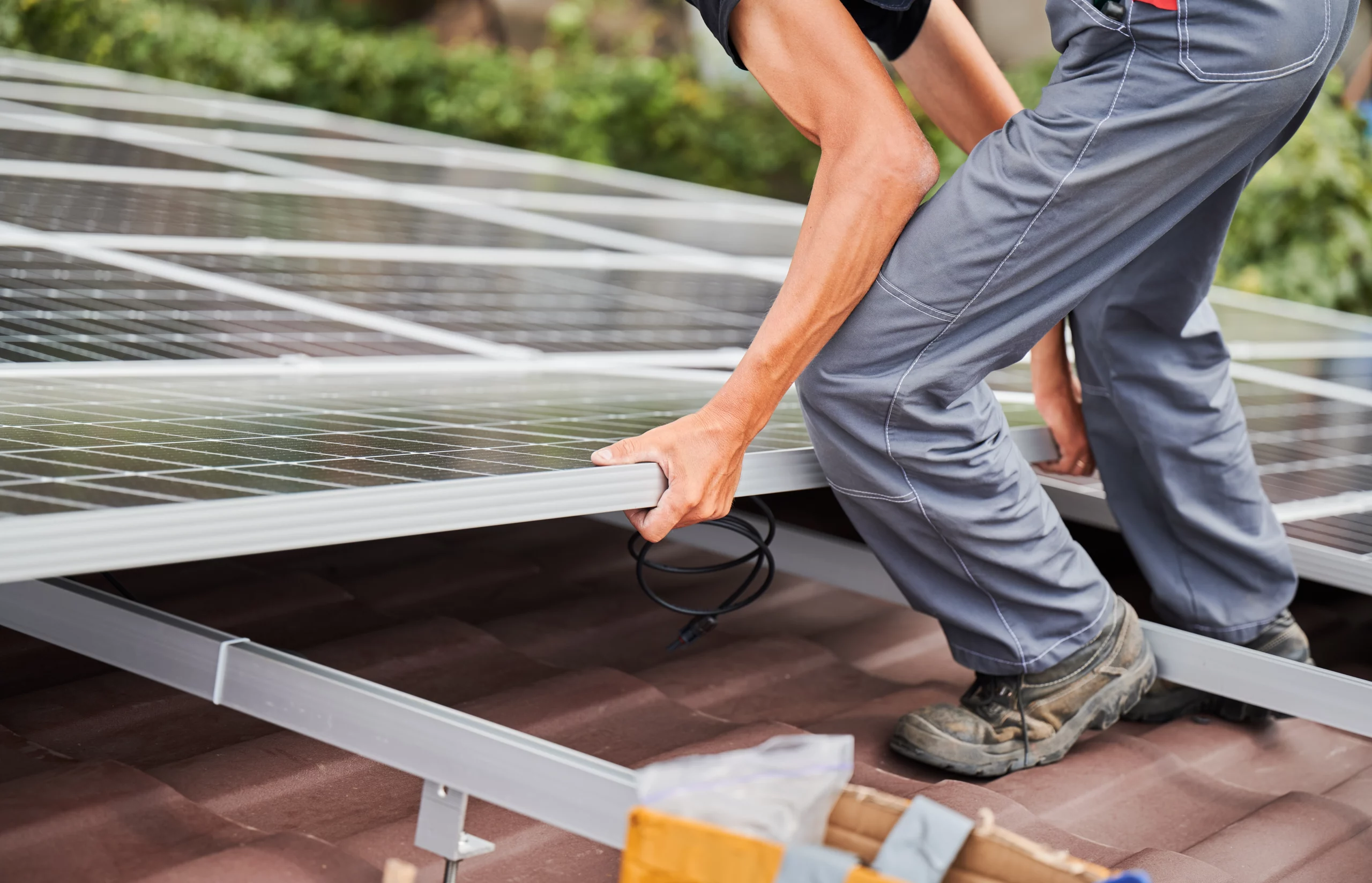 financial benefits of solar energy: men installing solar panels | Swoosh Finance