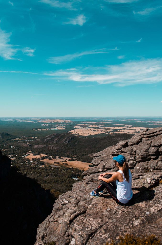 Woman looking out over rocky mountain valley