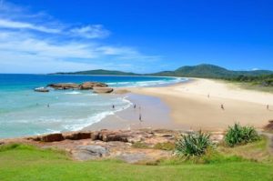 sunny beach and rocks in summer