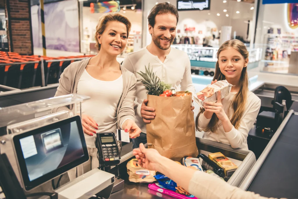 family paying for groceries on a holiday with a credit card