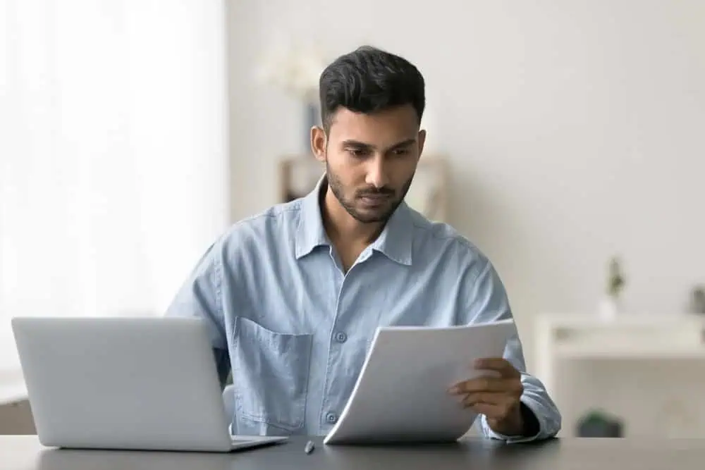 Man reviewing his bank account to seehow much rent assistance he can apply for | Swoosh Finance 