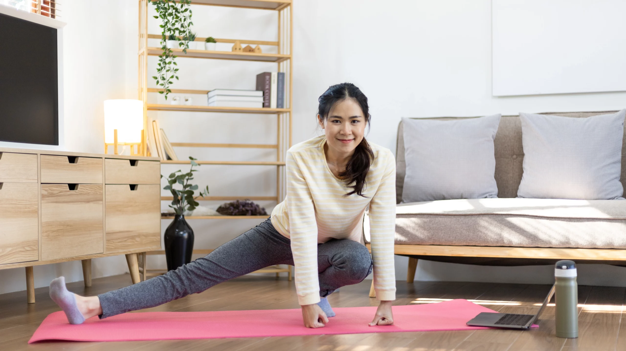 Cheapest ways to heat a house: woman working out in her home