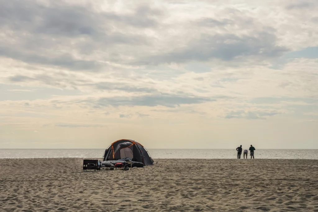 Cheap boys trip idea: beach camping | Swoosh Finance