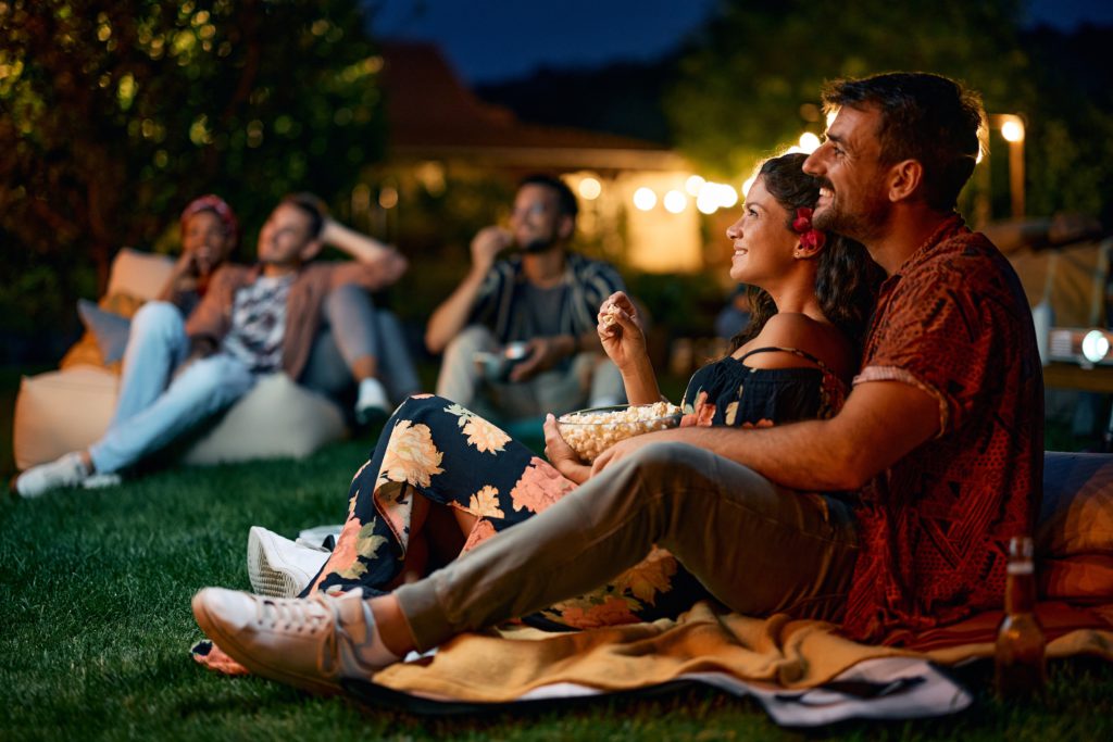 Couple enjoying free movie under the stars on the Gold Coast | Swoosh Finance