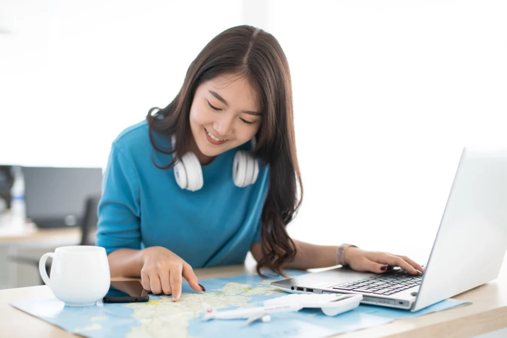 woman planning how to travel on a budget with an excel spreadsheet