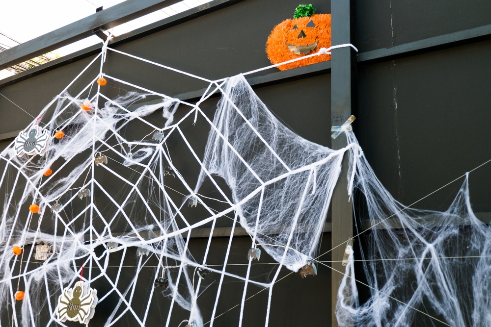 DIY spider webs on the porch made out of white thick string to give that spiderweb effect.