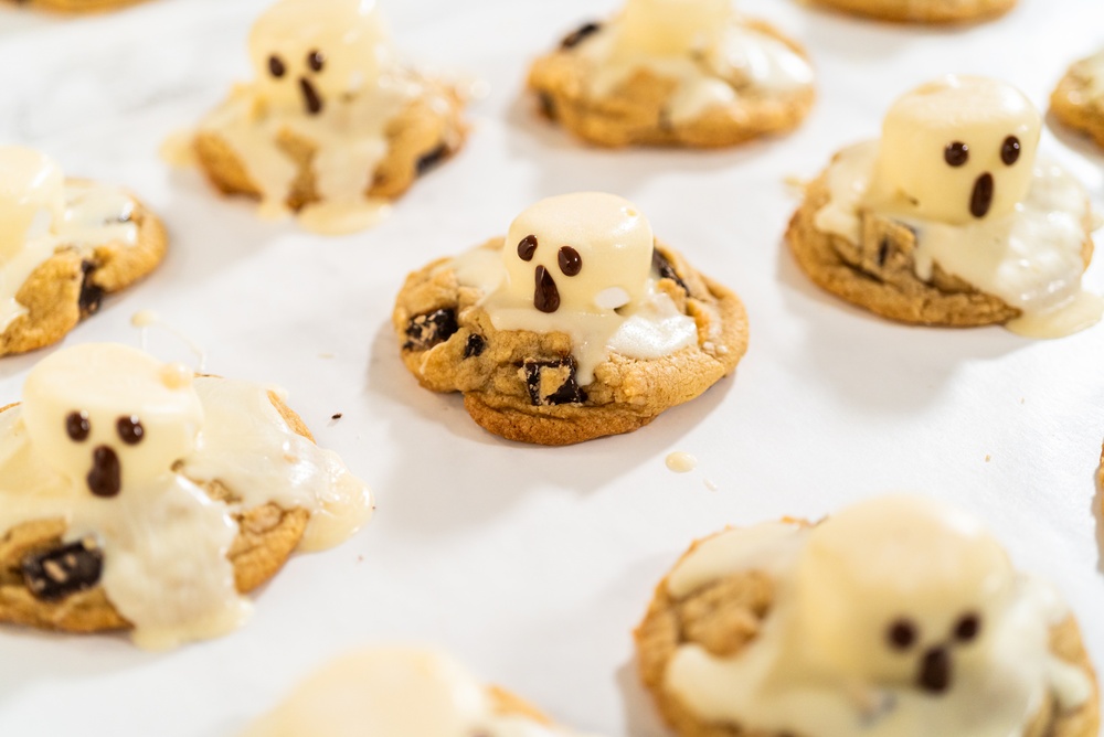Dripped marshmellows with black iced faces stuck on a cookie to look like ghosts.