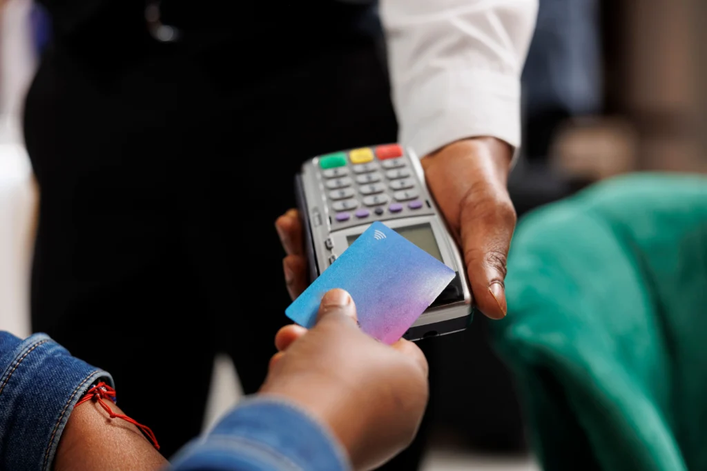 Woman using travel card at eftpos machine while travelling