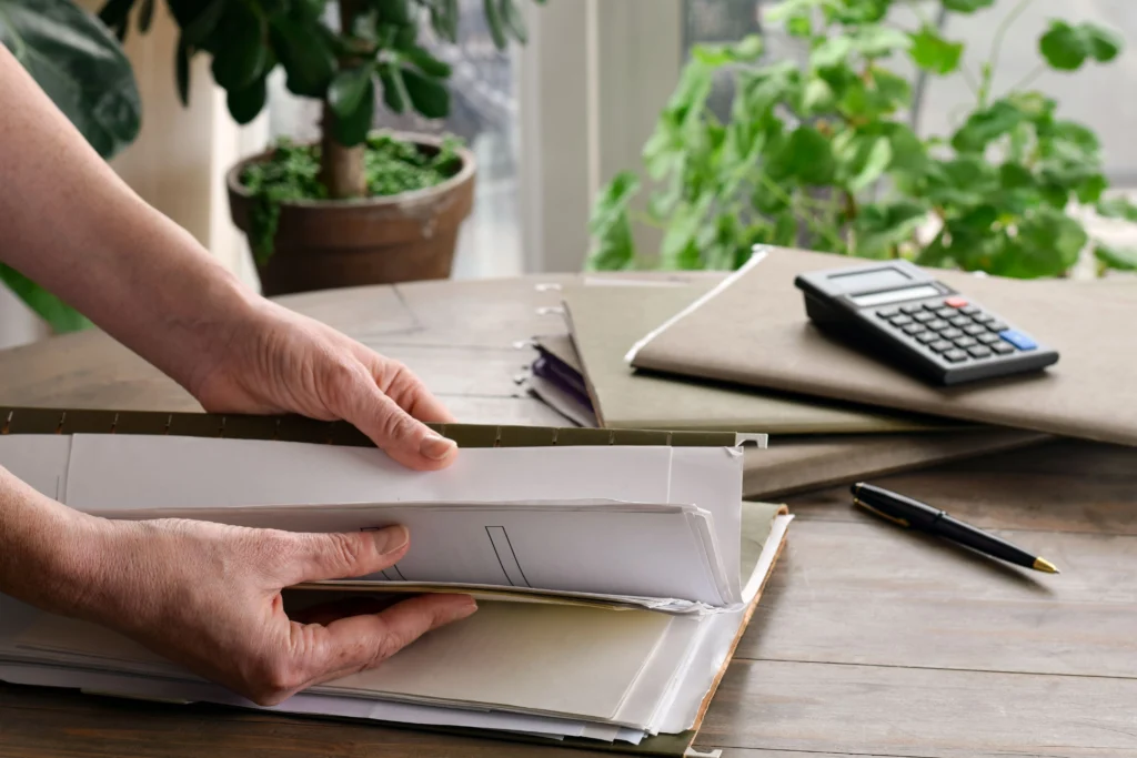 woman sorting through tax records kept in file folder