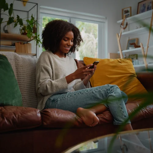 Woman applying for consolidation loan with bad credit on mobile phone | Swoosh Finance