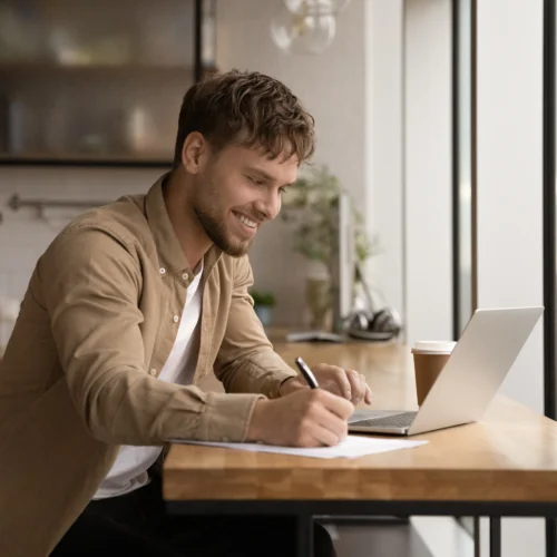 A man on his laptop in the kitchen applying for bad credit loans