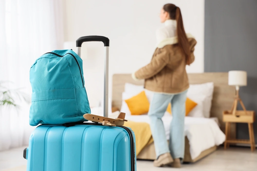 woman settling in at her budget travel accommodation