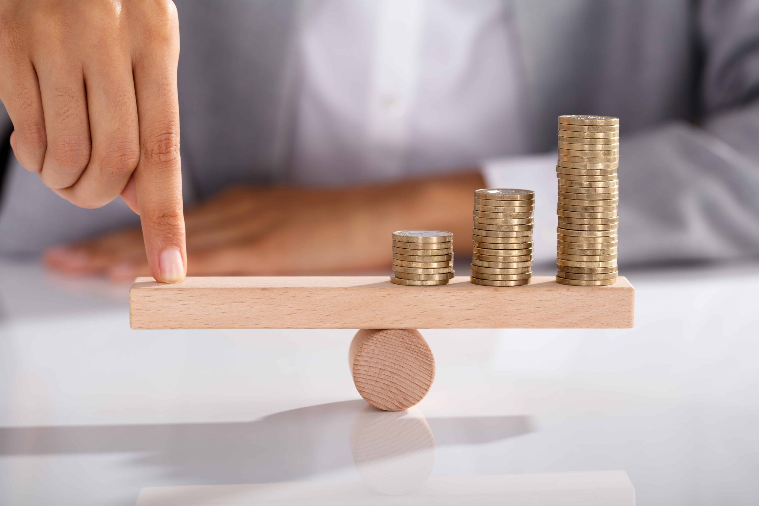 Balancing your credit score - money on one side and needing to balance on the other | Swoosh Finance
