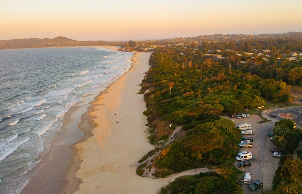 A view of Byron Bay at sunset during school holidays