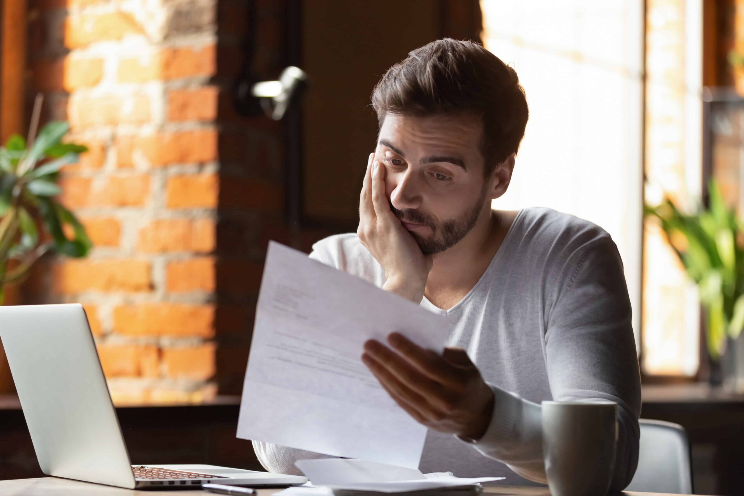 Confused man looking for an easy loan to get with bad credit history | Swoosh Finance