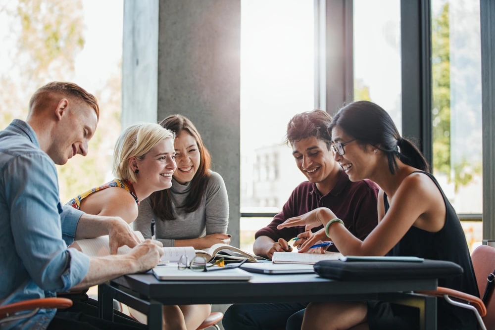 Group of uni students studying together | Swoosh Finance
