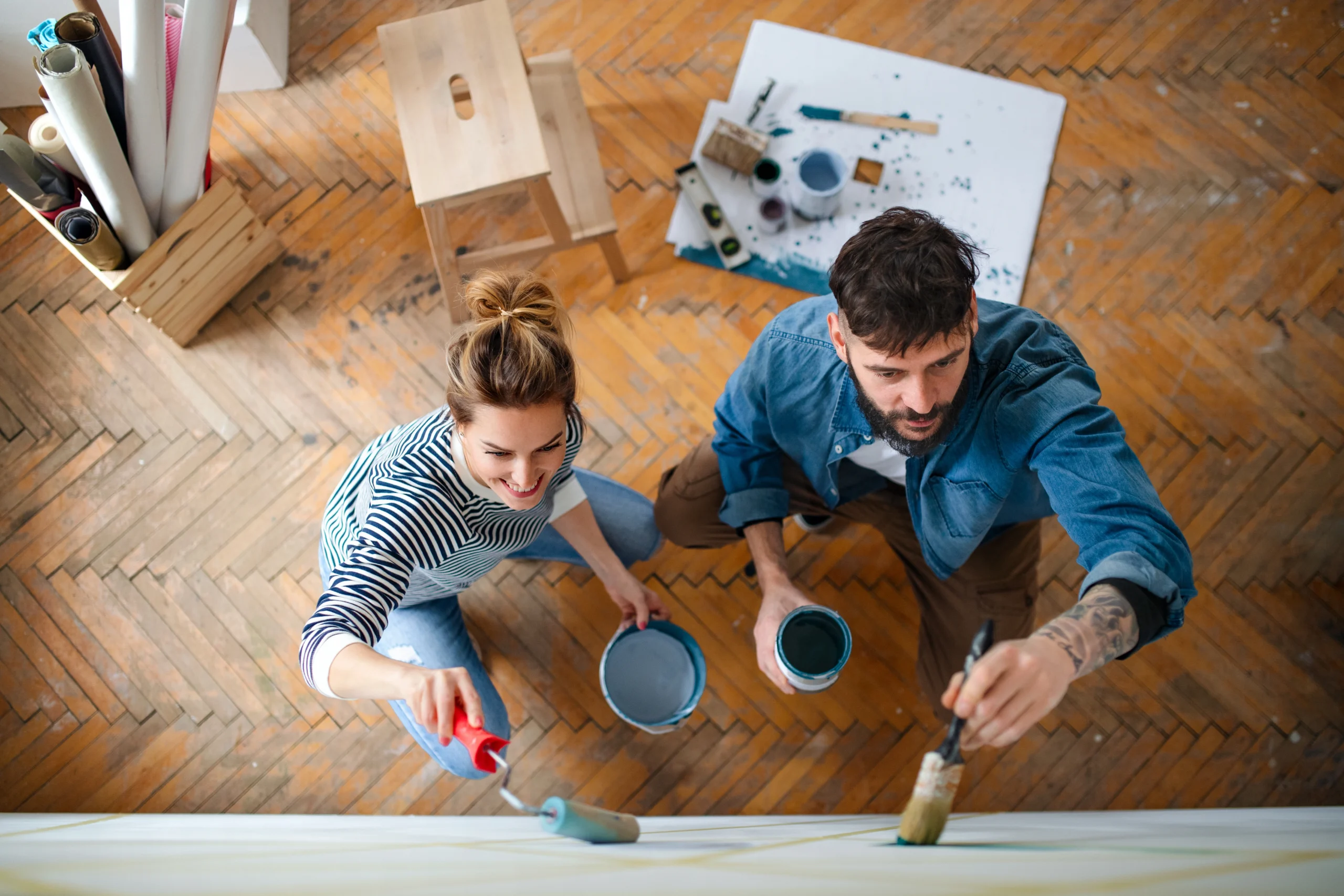 Bird's eye view of a couple painting their wall