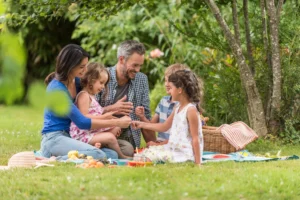 Family enjoing an outdoor picnic