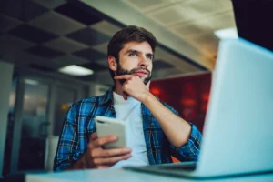 Man researching pros and cons of payday loans