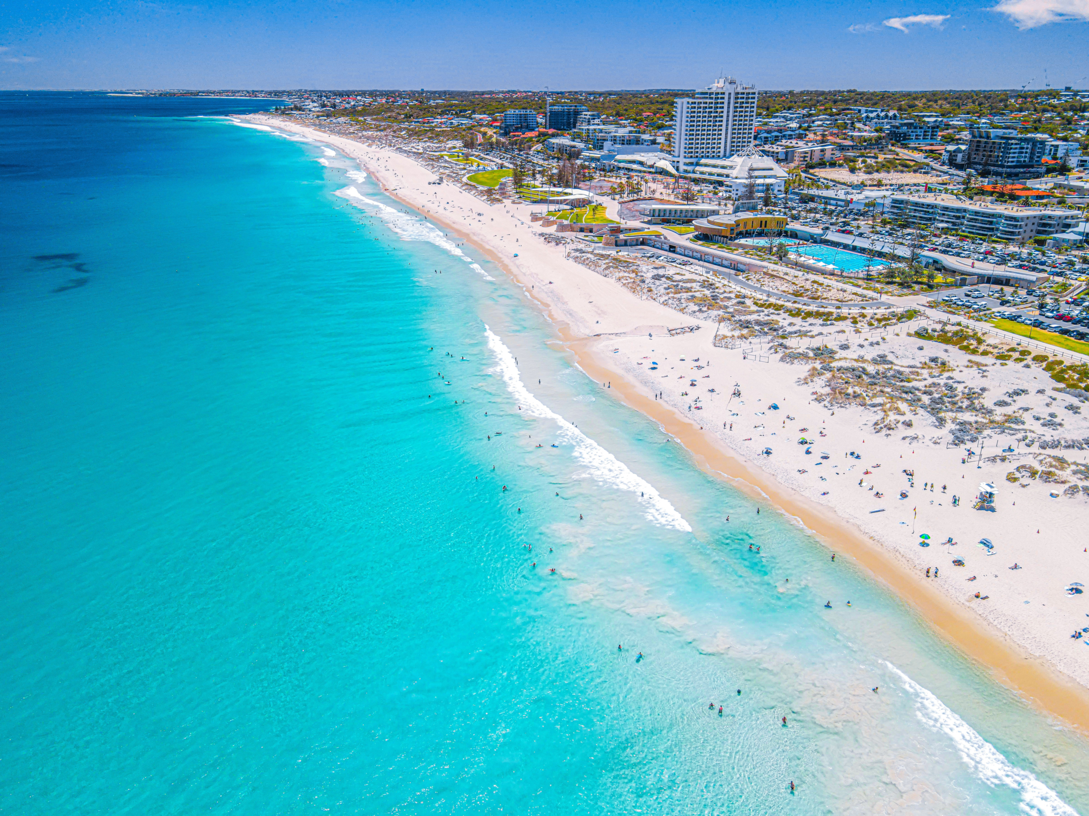 lots of people swimming and lounging at the beach for free in Perth