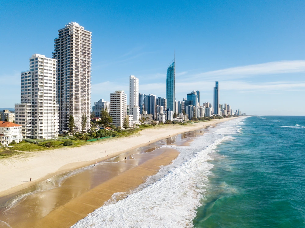 Surfer Paradise beach and city skyline with families during school holidays