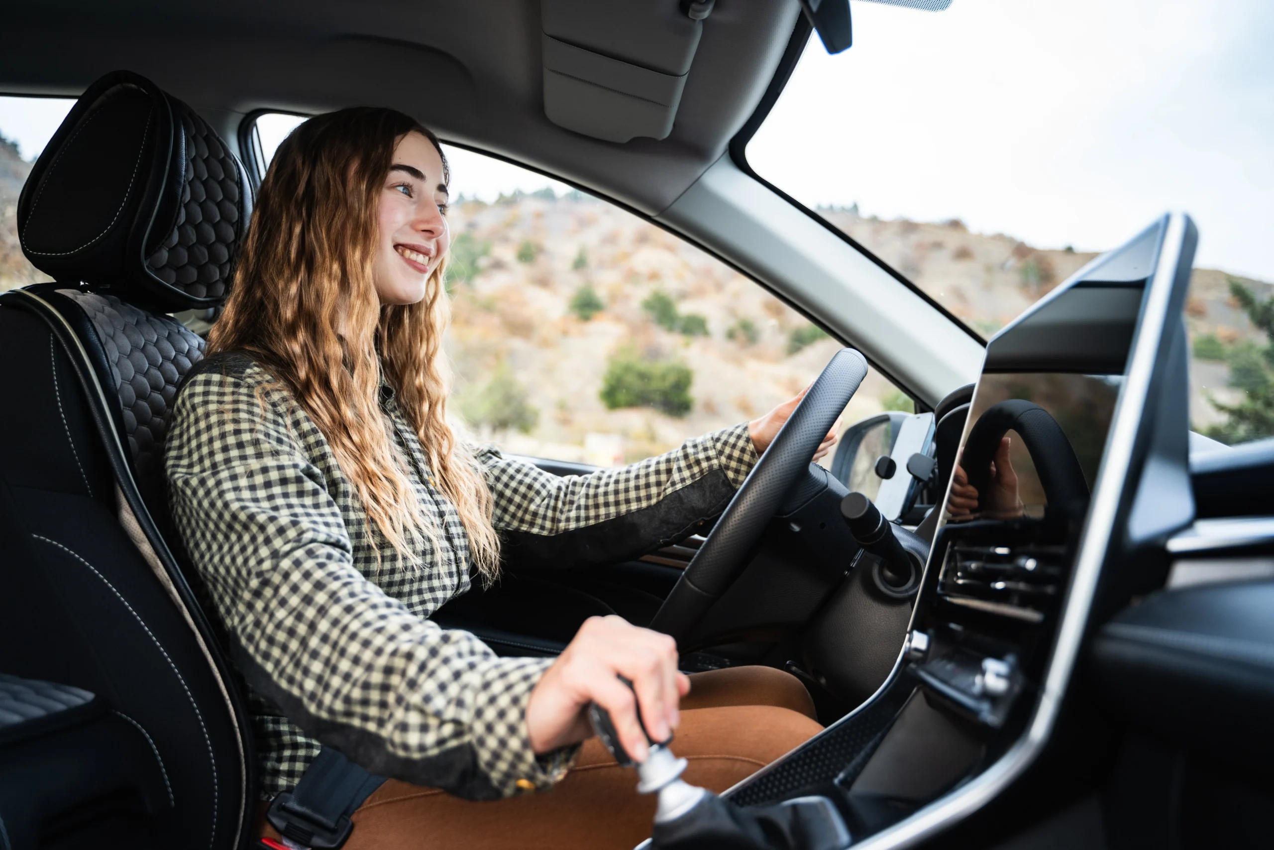 A woman driving a car after getting a loan against car