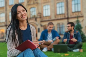 Uni student working on the grass