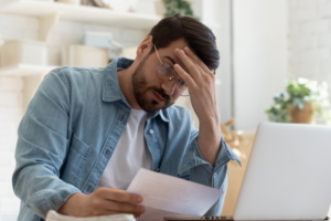 Worried man looking at his bills