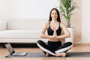 Woman doing yoga in her living room