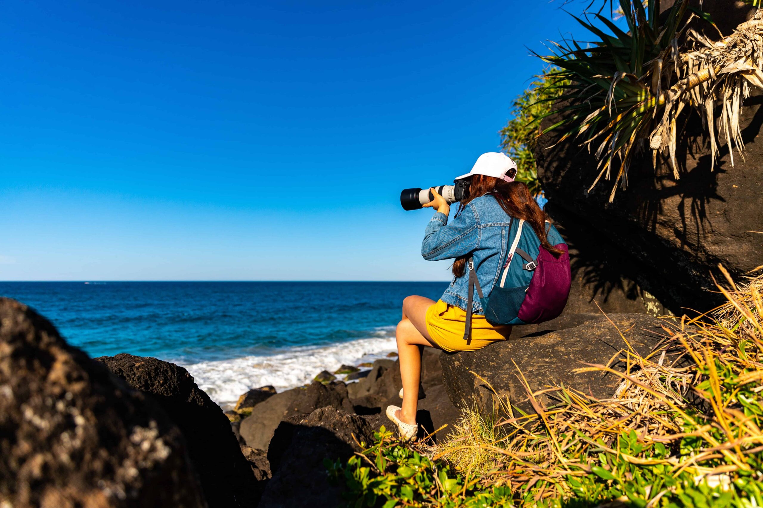 Photographer on rock along a beachside walk in the Gold Coast