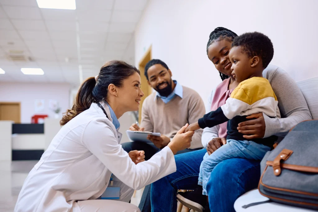 Parents and child sitting with a doctor at a hospital