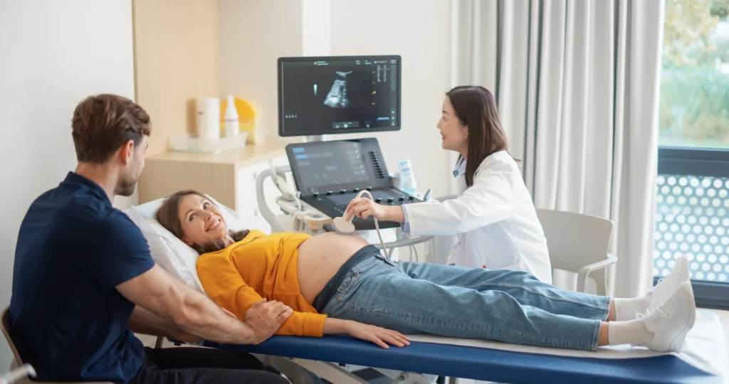 Pregnant woman and her partner getting a ultrasound at a clinic