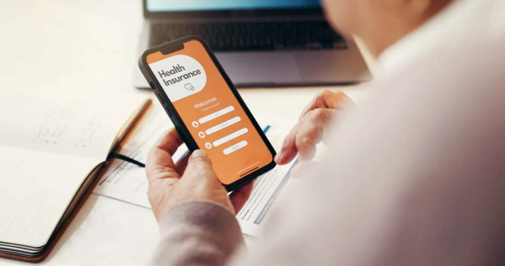 Person on their phone signing into their private health insurance app to look at their financial situation