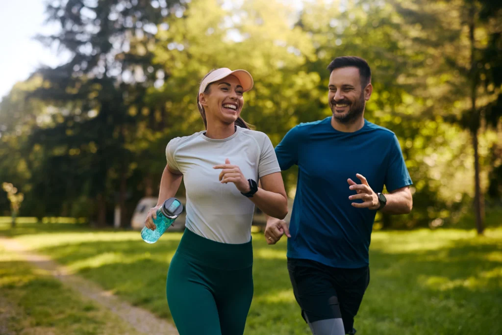 Healthy and happy young couple in their 20s going for a run outside