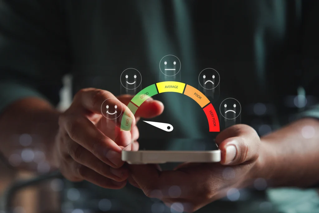 Close-up of a person using a smartphone displaying a credit score scale from excellent to very poor, illustrating how credit history affects borrowing options.