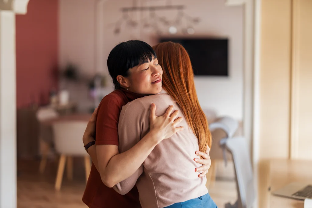 Two friends hugging and supporting each other during a meaningful R U OK Day conversation