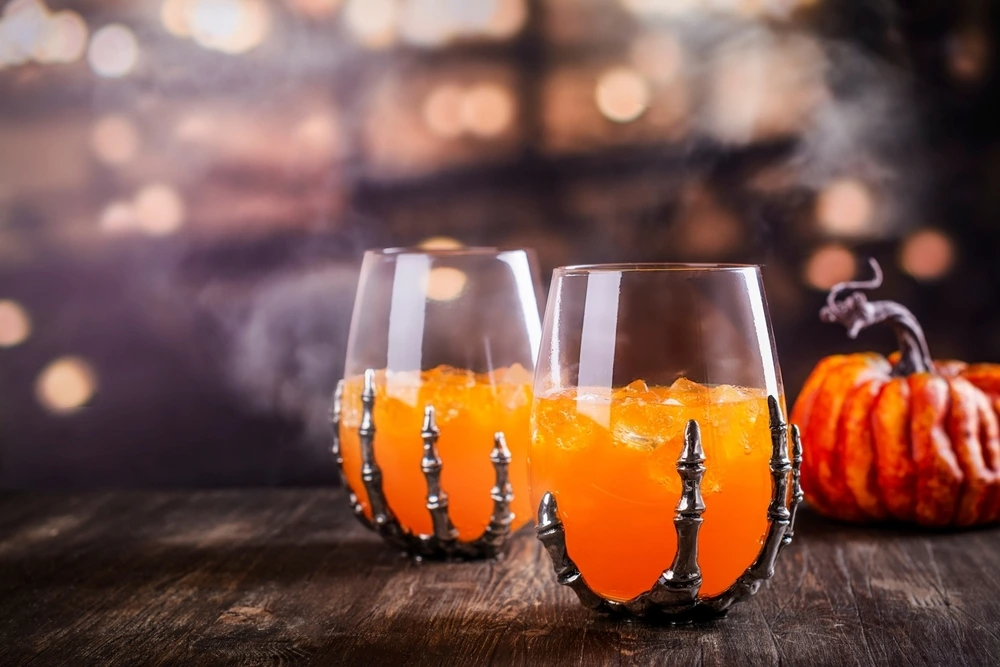 Alcholic cocktails in a spooky looking glass to fit into the spooky halloween theme.