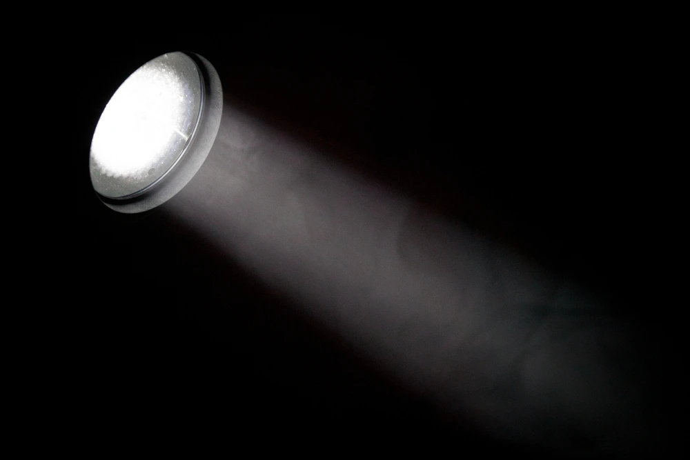 A big spotlight to represent a game of hide and seek in the dark.