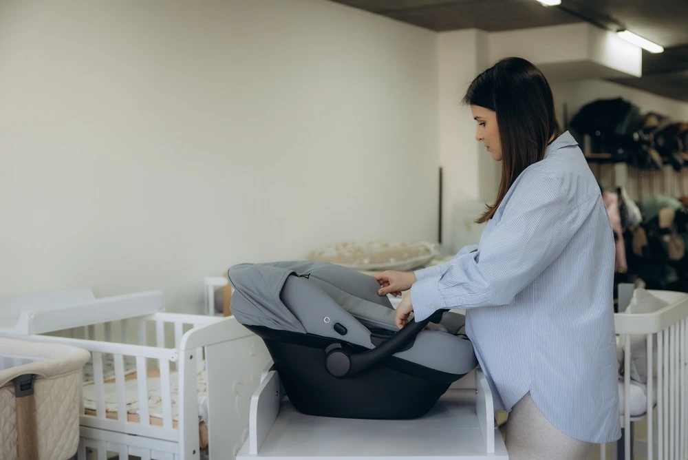 A first time mum looking at baby equipment and weighing up the costs